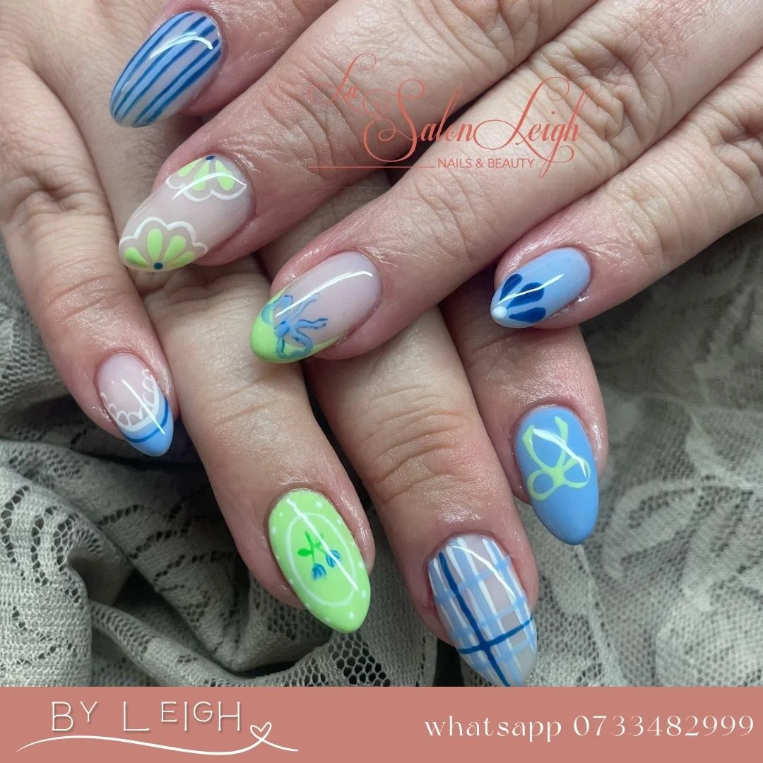 Intricate nail art design with floral patterns and glitter accents